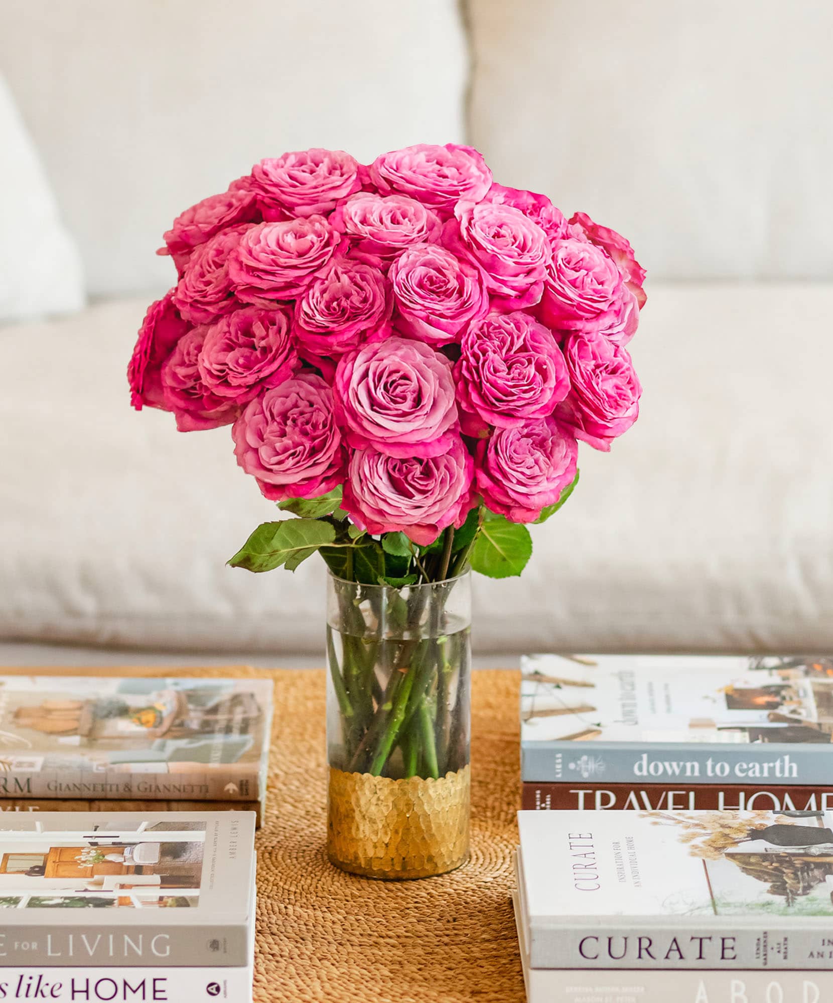 Vibrant pink roses elegantly arranged in a chic glass vase, perfect for home decor.
